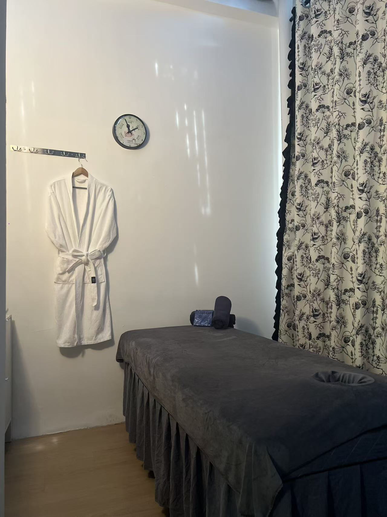 Treatment room with massage bed and robe